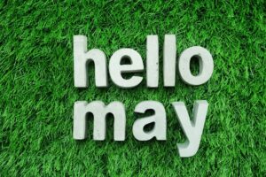 The words hello and may spelled in patch of green grass