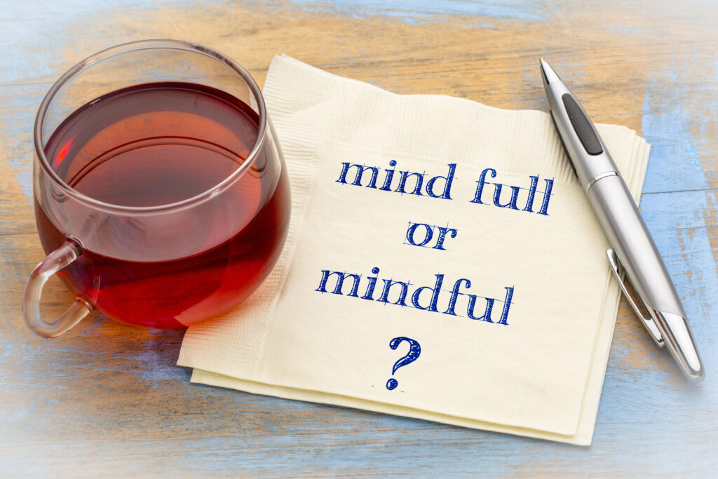 Cup of tea, with napkin that reads Mind full or mindful?