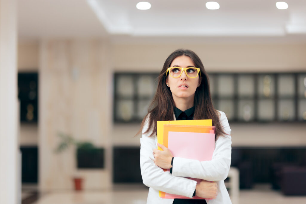 Worried Businesswoman Holding Paperwork in Office Building